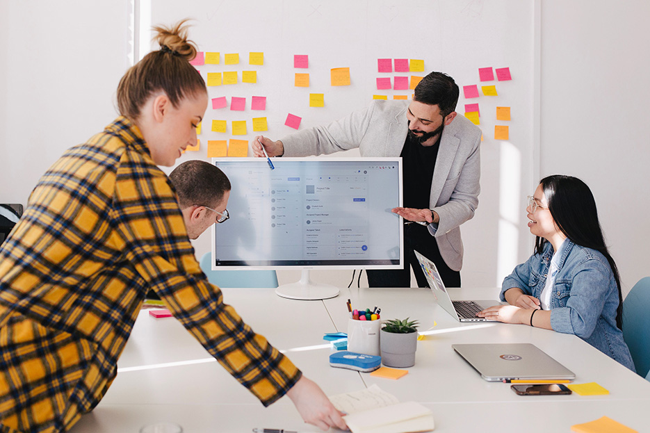 people gathered around table planning website development